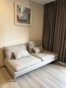 a bed with two pillows on it in a room at Politan Breeze, Chaophraya River view in Ban Sai Ma +19 photos