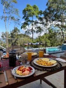 a wooden table with plates of breakfast food on it at Indigo House, Villa Fez in San Francisco