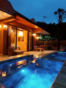 a swimming pool in front of a house at night at Indigo House, Villa Fez in San Francisco