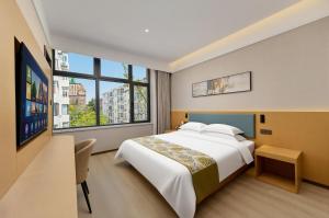 a bedroom with a large bed and a large window at Shiershan · Yuntang Hotel in Qingdao +72 photos