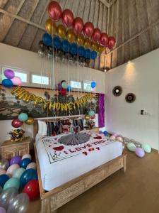 a room with a bed with balloons and a bed with a cake at Suara Jiwa Luxury Villas with Private Pool in Ubud +123 photos