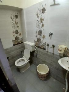 a bathroom with a toilet and a sink at Agam Homestay - Few Steps From golden temple in Amritsar