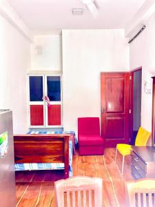 a living room with red and yellow chairs and a table at Studio Greenlands 2nd D-Battaramulla in Talangama South