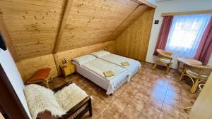 a bedroom with a bed and a table and chairs at Penzion Soukupovi in Strážné