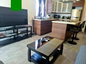 a kitchen with a counter and a table in it at Scandi Villas Boracay by Simple Realty Management in Boracay
