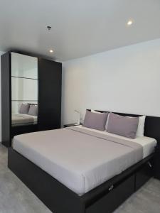 a bedroom with a large bed and a mirror at Scandi Villas Boracay by Simple Realty Management in Boracay +18 photos