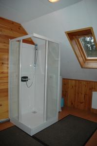 Una ducha de cristal en una habitación con techo en Dortoirs Le Domaine, en Bilstain