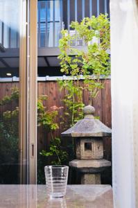 a stone bird feeder sitting in a garden at waen in Karahashi Rashomon