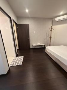a bedroom with a bed and a table and a door at waen in Karahashi Rashomon