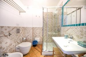 a bathroom with a toilet and a sink and a shower at Agrodolce B&B in Cefalù +41 photos