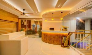 a lobby of a hotel with a bar at Casa Verde in Cochin