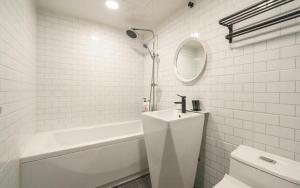 a bathroom with a sink and a tub and a toilet at My 24 Motel in Incheon +34 photos