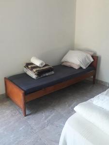 a bed with a pillow and a phone on top of it at Posada Ña Arminda in Capitán Miranda