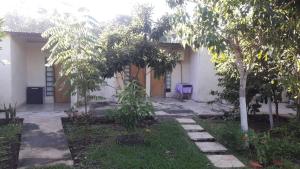 a house with a garden in front of it at Posada Ña Arminda in Capitán Miranda