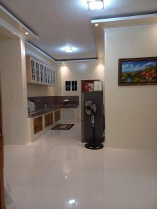 a kitchen with a black refrigerator in a room at Spacious Villa in Baclayon