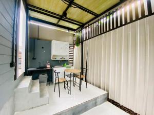 a kitchen and dining area of a building with a table and chairs at Thawat Villa Boutique Resort in Ko Lanta