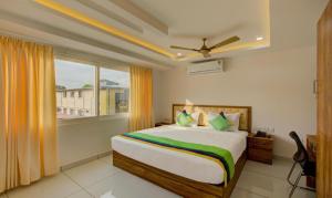 a bedroom with a bed and a large window at Casa Verde in Cochin
