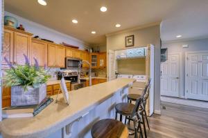 a kitchen with wooden cabinets and a kitchen island with stools at Sugar Mountain Condo, Sleep 4, Deck Mountain Views in Sugar Mountain