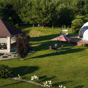 an aerial view of a yard with a tent at Pavasario Namai & SPA in Alytus