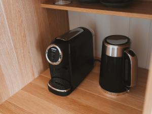 a toaster sitting on a shelf next to a coffee maker at Commercial Hotel Boonah in Boonah
