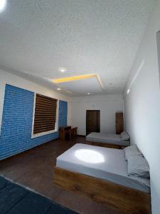 a room with a bed and two beds in it at Deep Villa in Batheri +15 photos