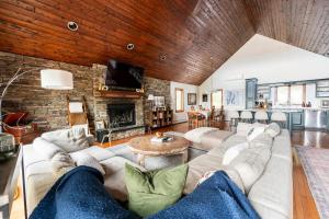 a living room with a couch and a fireplace at Mountain View Chalet Ski, Hot Tub, Firepit, Games in Lexington