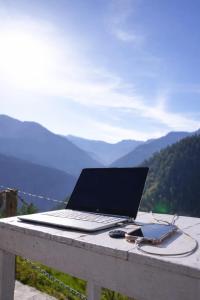 a laptop computer sitting on top of a table at The Crystal Cabin in Jibhi