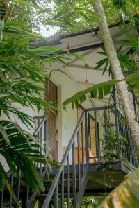 a house with a staircase leading to a door at Deep Villa in Batheri