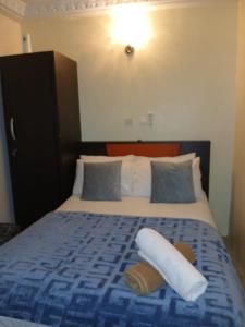 a hotel room with a bed with two pillows at Natako Apartments in Apenkwa