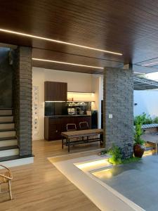 a living room with a table and a kitchen at The SeaNest Home - Làng Chài Mỹ Tân Ninh Thuận in Vinh Hai