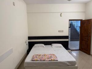 a bedroom with a bed in a room with a staircase at S G S LOADGING aND BOARDING in Dod Ballāpur