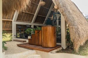 a large wooden barrel sitting outside of a house at La Brava Bali I Private Luxury Villas in Bingin, Uluwatu in Uluwatu