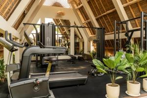 a gym with a treadmill and plants at La Brava Bali I Private Luxury Villas in Bingin, Uluwatu in Uluwatu