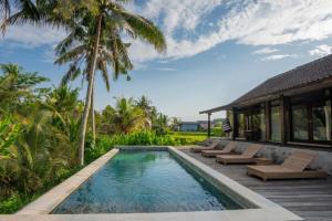a villa with a swimming pool and a resort at Harmony Heaven Ubud by The Travel Ubud Bali in Ubud