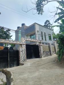 a house with a fence in front of it at Speke homes full apartment!!! in Kabale