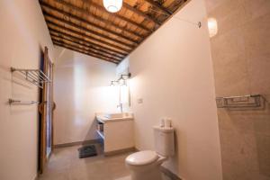 a bathroom with a toilet and a sink at Harmony Heaven Ubud by The Travel Ubud Bali in Ubud +77 photos