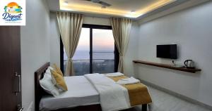 a bedroom with a bed with a large window at Digant Home Retreat in Nevra