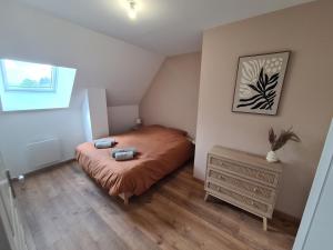 a small bedroom with a bed and a window at Au pré de Mimi in Lalande-en-Son