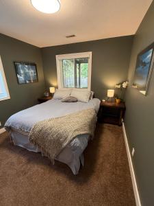 a bedroom with a large bed and a window at Tall Trees Departure Bay Nanaimo in Nanaimo +13 photos