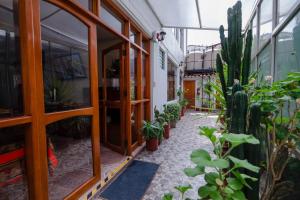 a courtyard with potted plants in a building at Quechua Hostal Recoleta in Cusco
