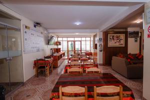 a room with a table and chairs and a couch at Quechua Hostal Recoleta in Cusco
