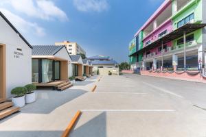 an empty street in front of a building at YUDream Mini Village in Ban Talat Rangsit
