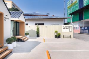 a courtyard with benches and a sign in a building at YUDream Mini Village in Ban Talat Rangsit
