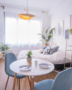 a living room with a table and chairs and a bed at Studio charmant au centre-ville in Charleroi +13 photos