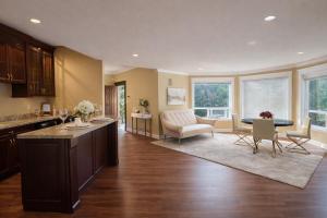a kitchen and living room with a table and chairs at Hampton Luxe House in Coquitlam