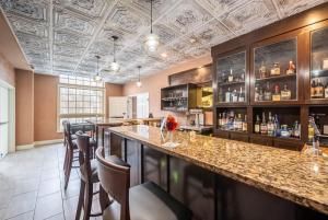 a bar with a counter and chairs in a room at Bellissimo Hotel, Trademark by Wyndham Near Foxwoods Casino in North Stonington