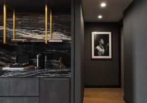 a bathroom with a black marble counter and a picture at Thompson Central Park New York, by Hyatt in New York +121 photos