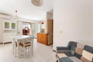 a kitchen and living room with a table and a couch at 066 Le Fontanelle by SalentoInVacanzaCOM in Fontanelle +30 photos