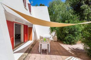 a patio with a table and chairs in a house at 066 Le Fontanelle by SalentoInVacanzaCOM in Fontanelle