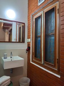a bathroom with a sink and a window at rumah566 in Yogyakarta +32 photos